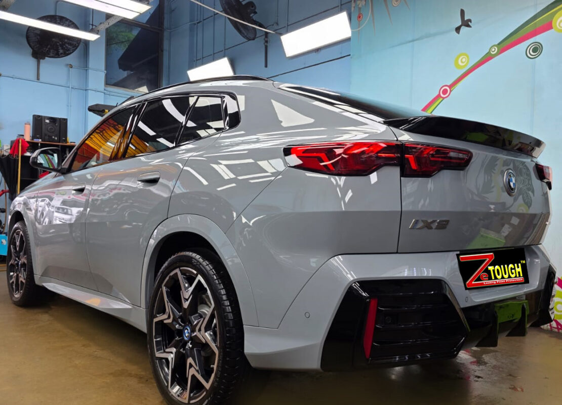 Rear quarter of the BMW iX2, glossy and protected.