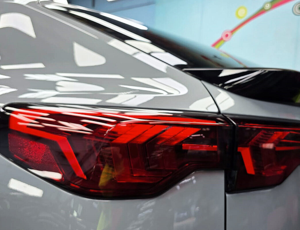 The coated bonnet of the BMW iX2 under workshop lighting.