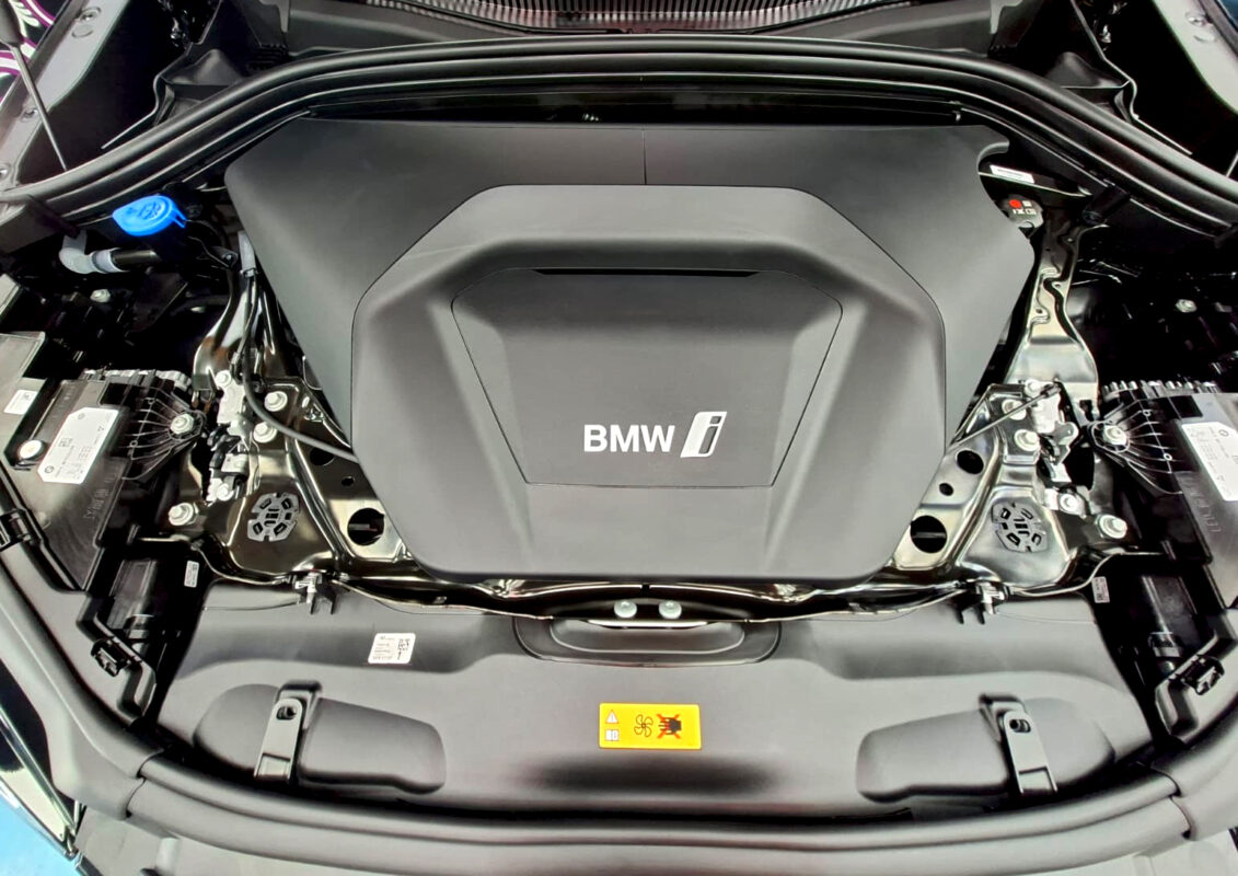 Reflections across the coated panels of the BMW iX2.