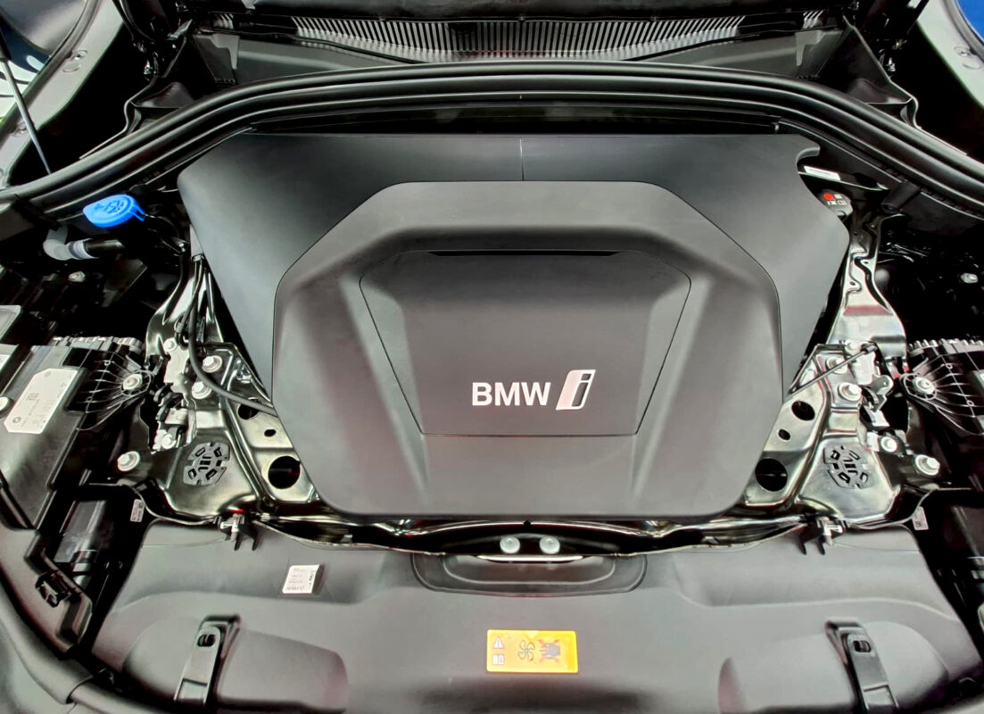 Reflections across the coated panels of the BMW iX2.