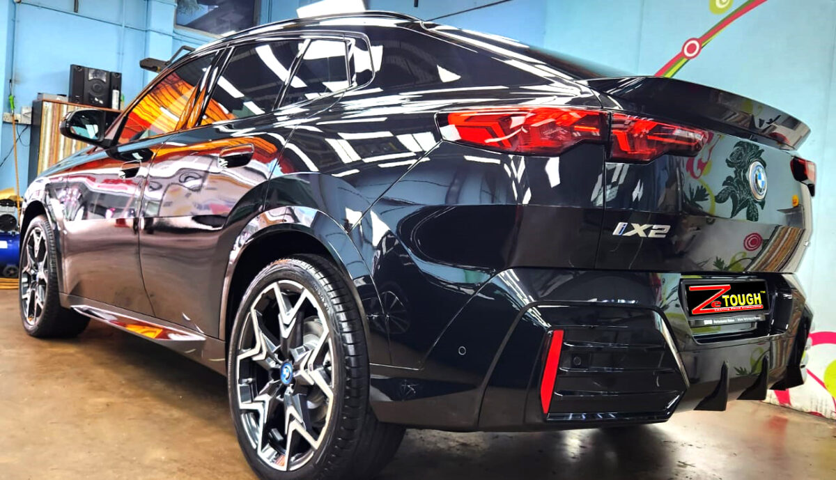 Rear quarter of the BMW iX2, glossy and protected.
