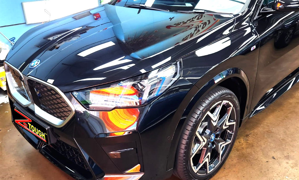 The BMW iX2 from a side angle after the ceramic coating.