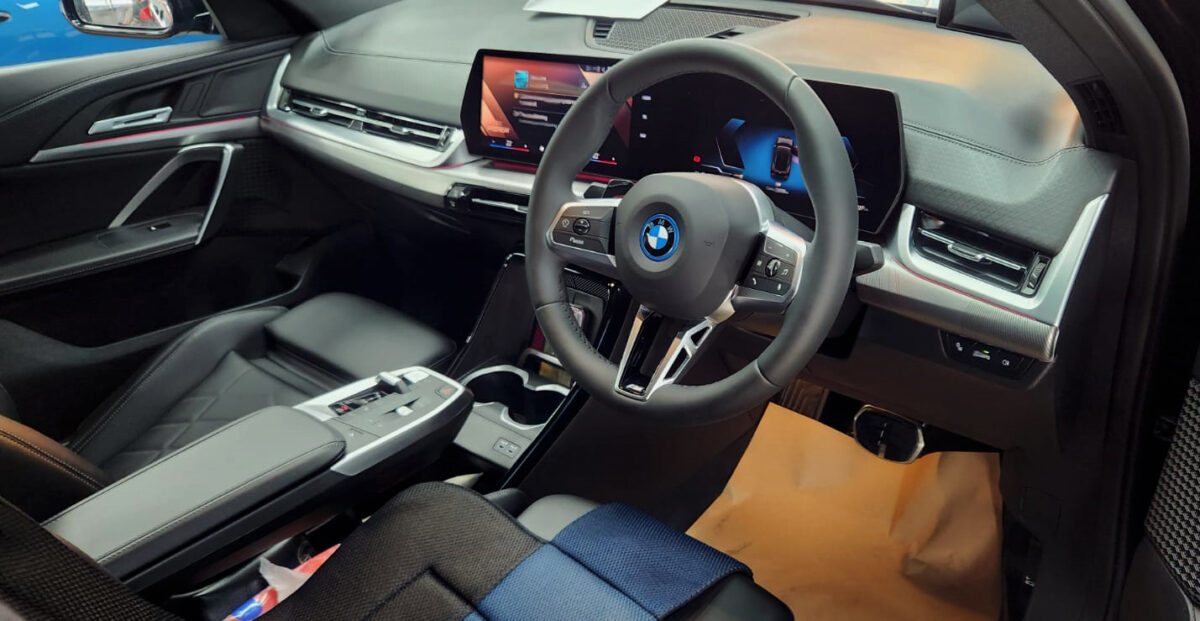 The BMW iX2 parked in the workshop, freshly coated.
