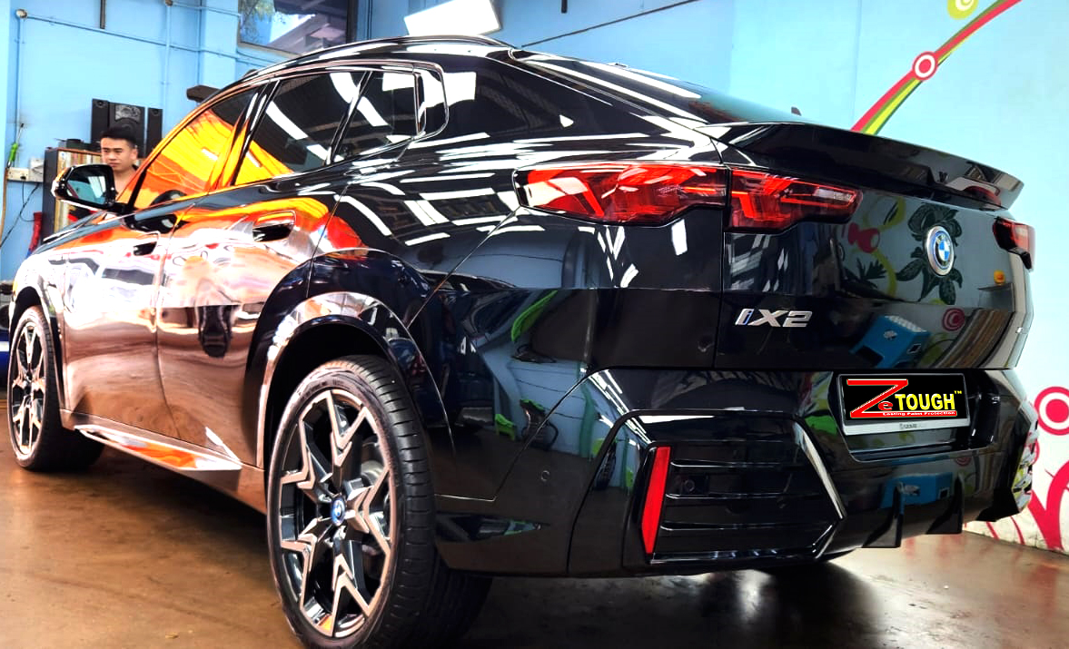 Rear quarter of the BMW iX2, glossy and protected.