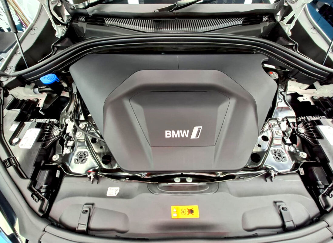 Reflections across the coated panels of the BMW iX2.