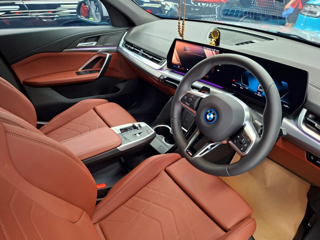 Reflections across the coated panels of the BMW iX2.