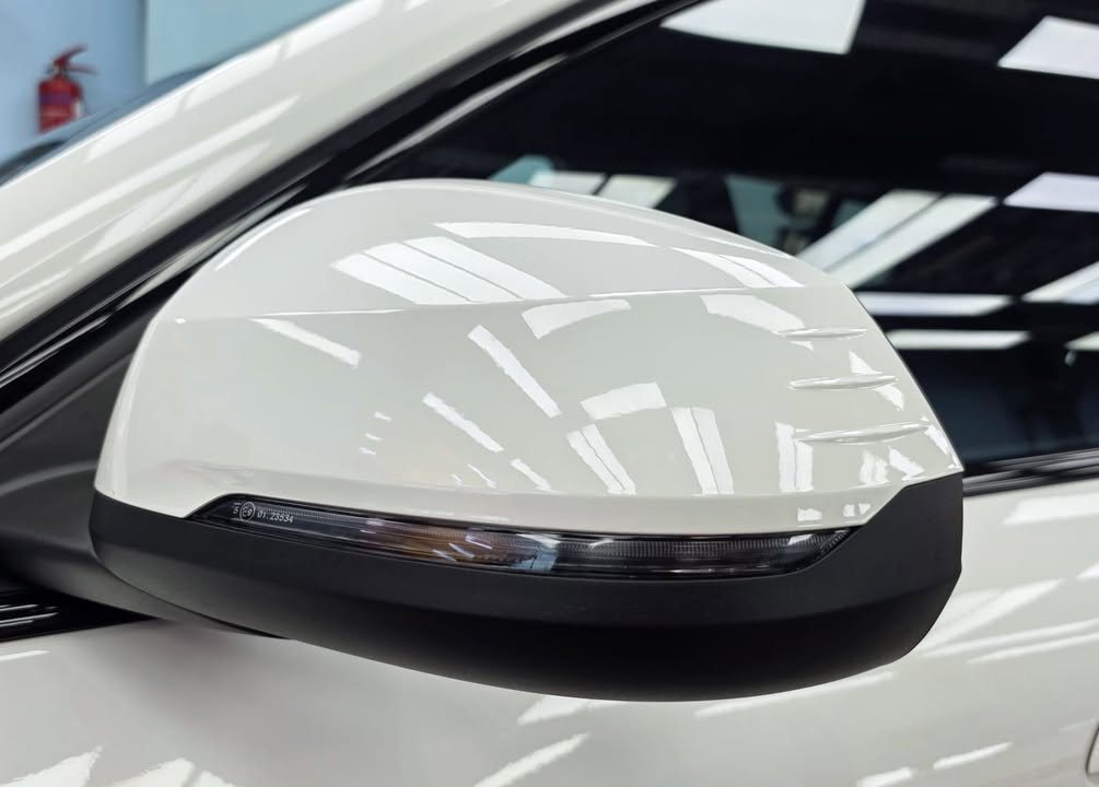 White door mirror with black base on the BMW iX2.