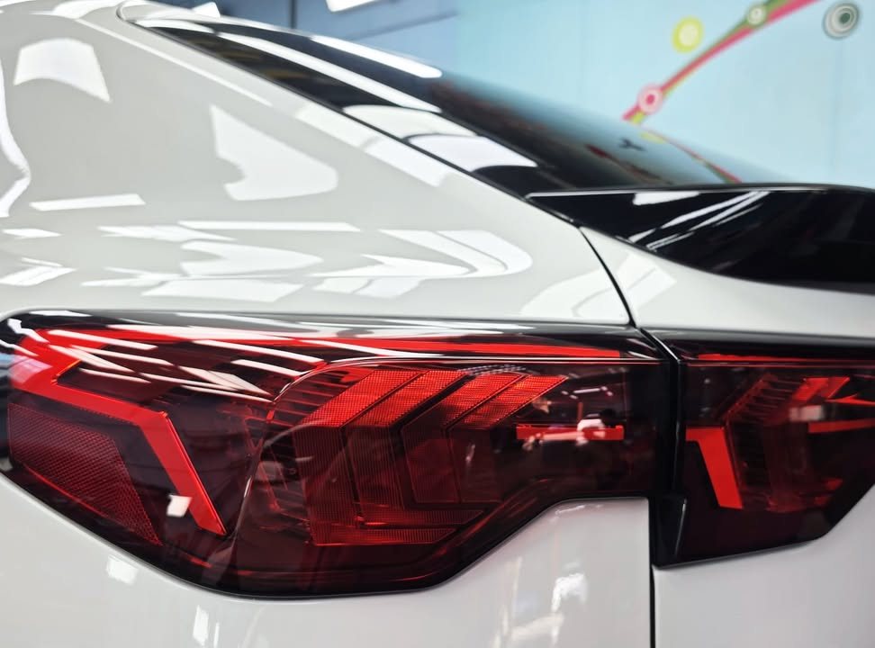 Close-up of the BMW iX2 tail lamp and white rear quarter.