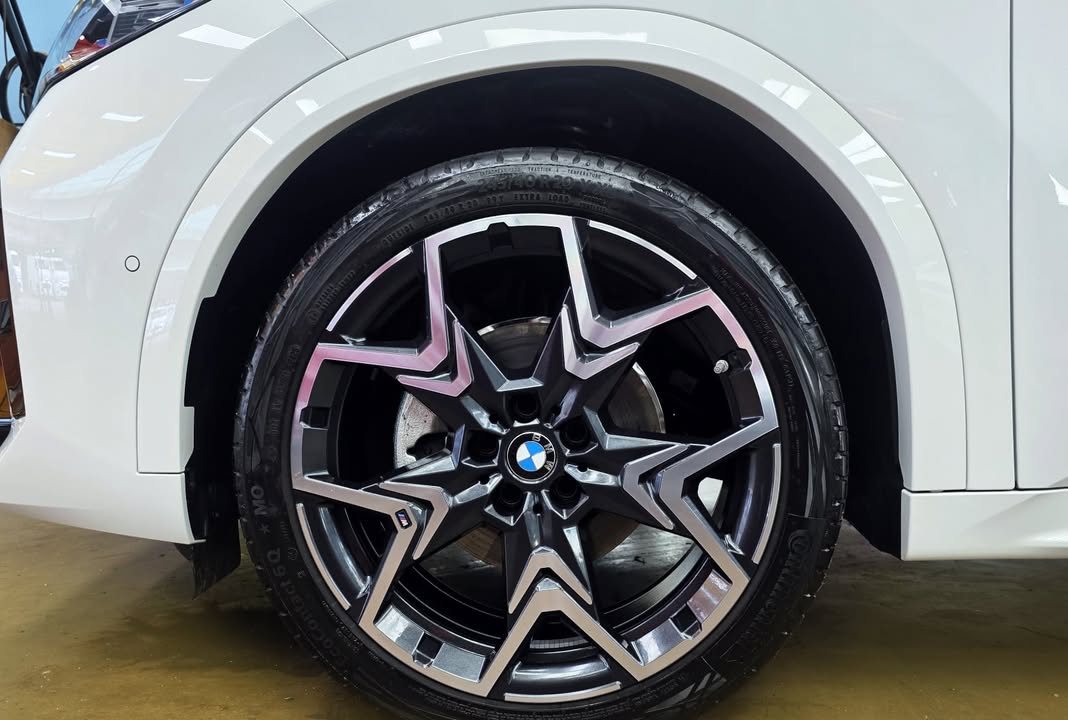 Two-tone alloy wheel on the white BMW iX2.