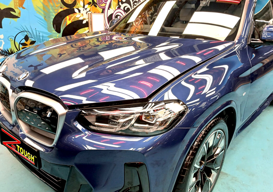 The BMW iX3 from a side angle after the ceramic coating.