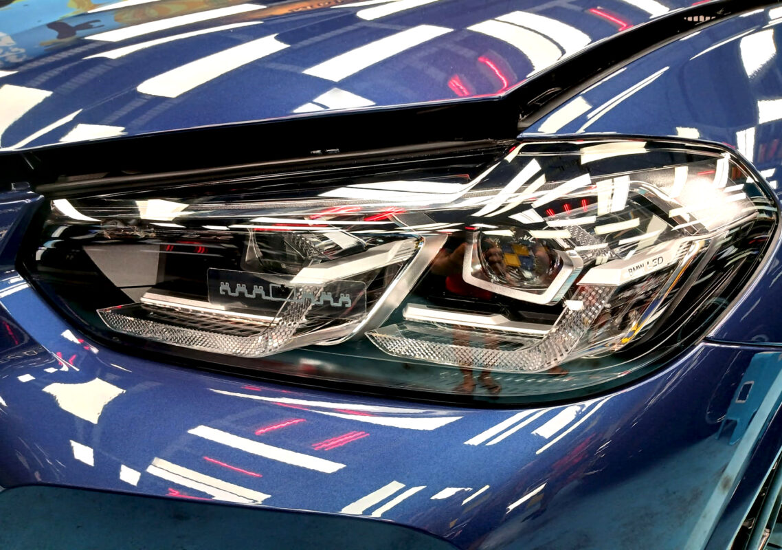 The iX3's coated paintwork showing clean reflections.
