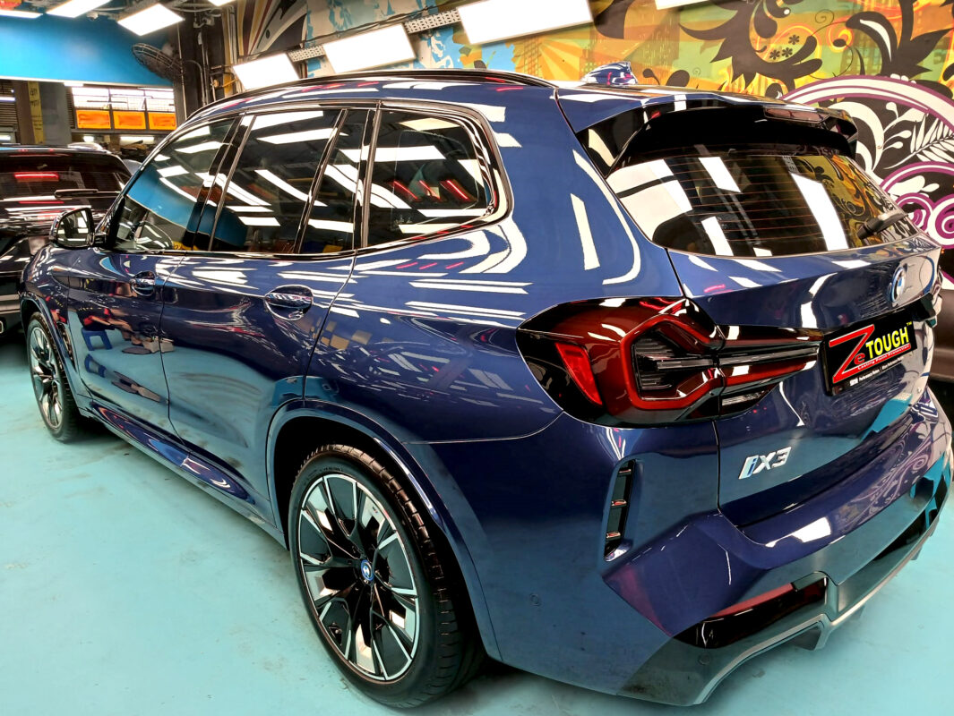 Rear quarter of the BMW iX3, glossy and protected.