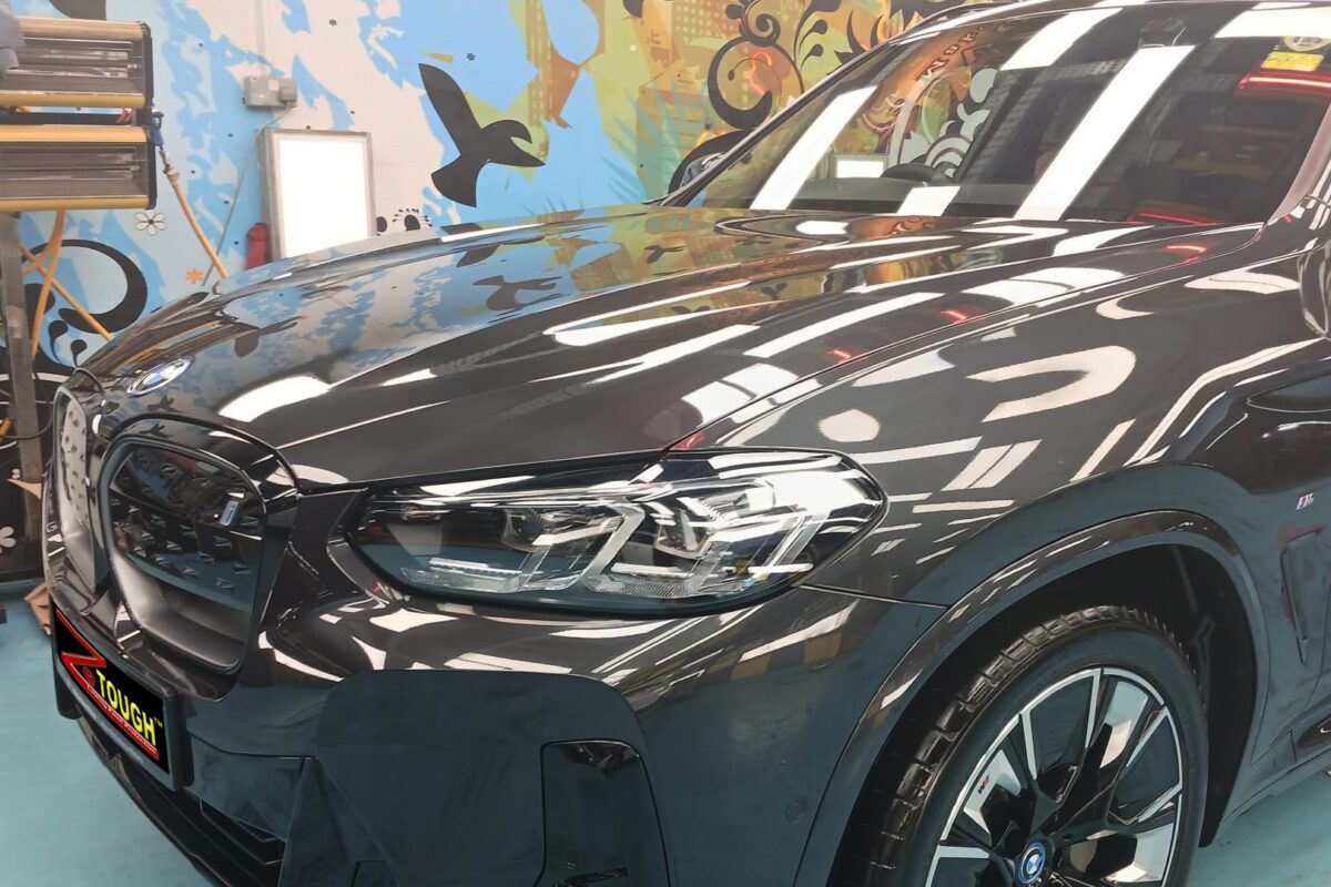 The BMW iX3 from a side angle after the titanium coating.