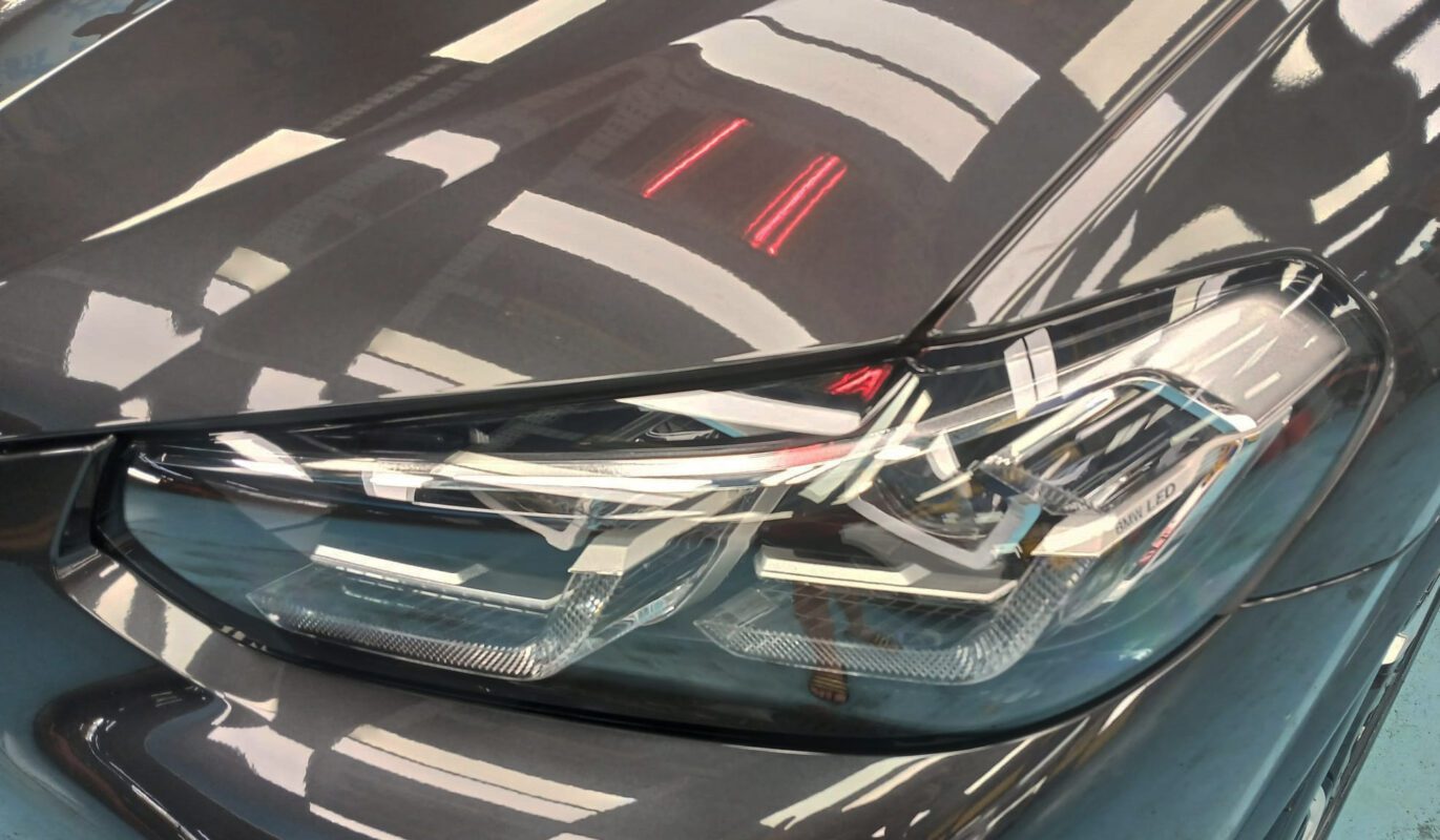 The iX3's coated paintwork showing clean reflections.