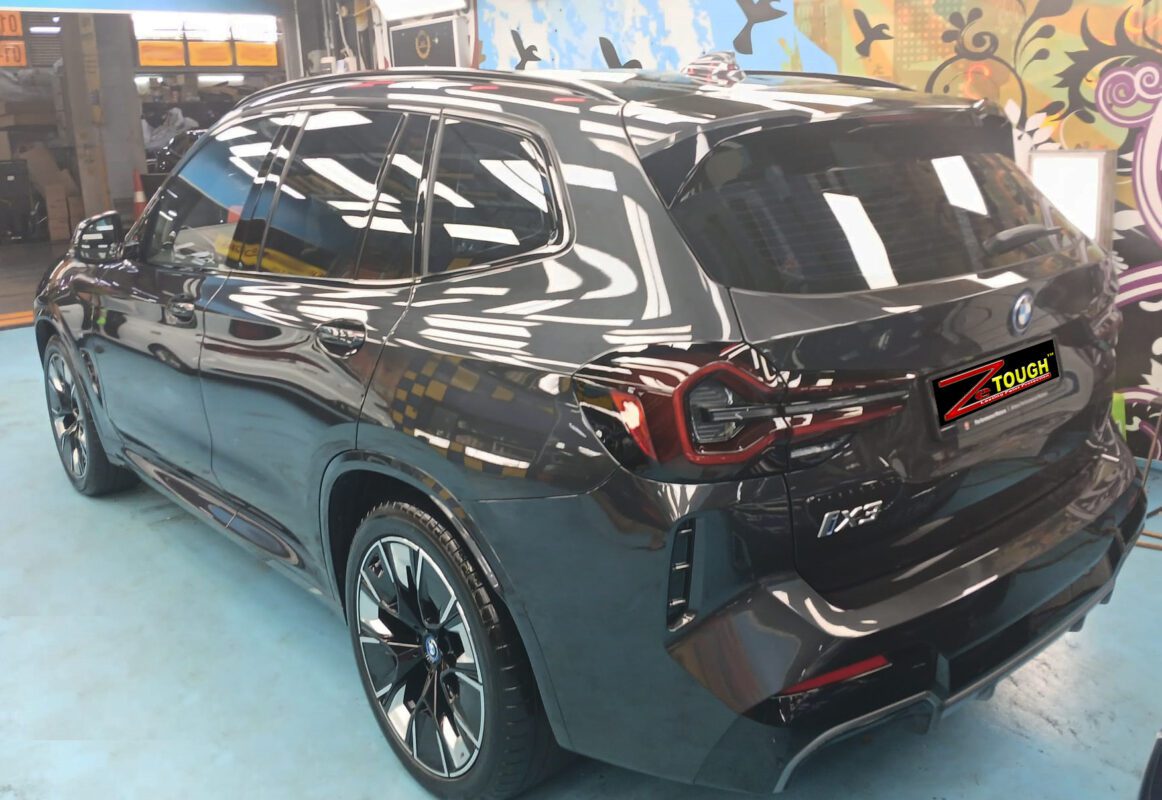 Rear quarter of the BMW iX3, glossy and protected.