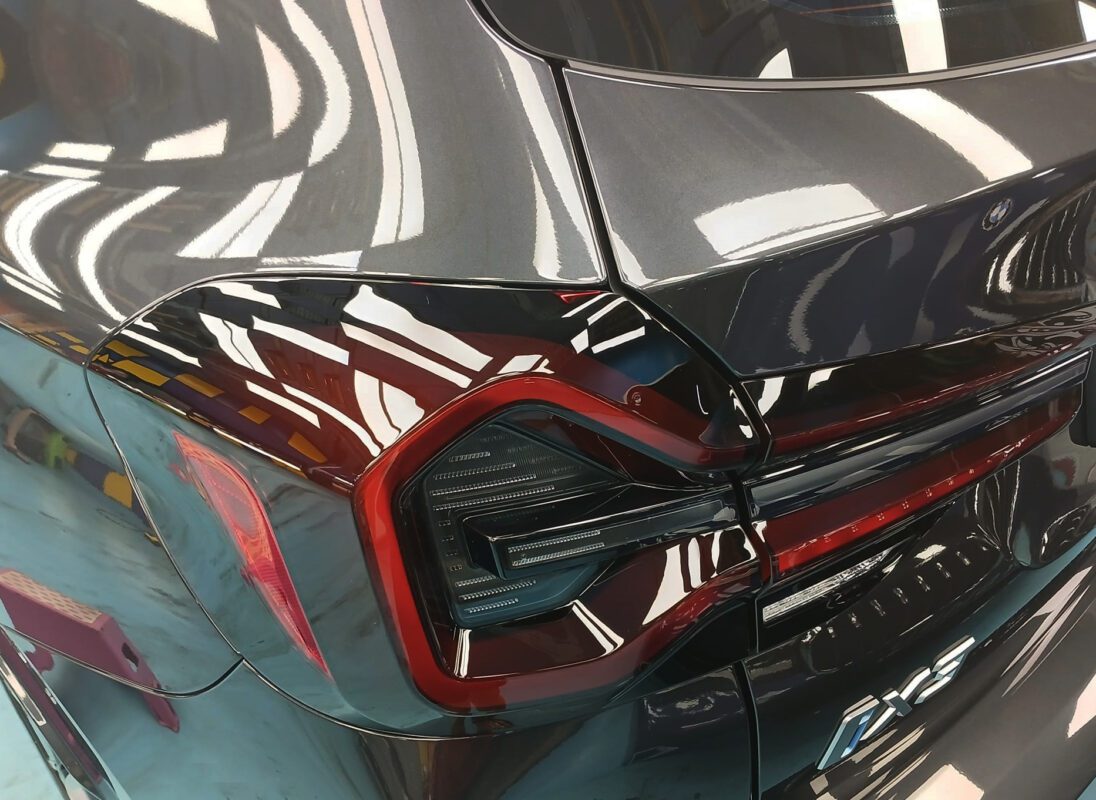 The coated bonnet of the BMW iX3 under workshop lighting.