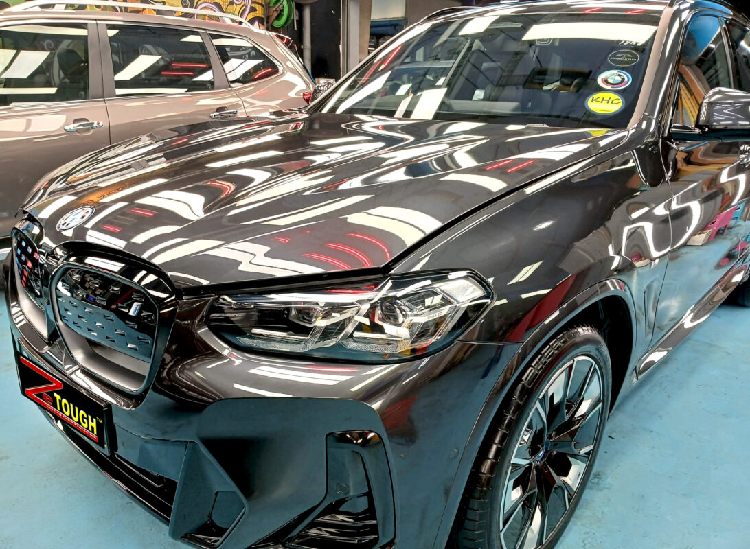 The BMW iX3 from a side angle after the titanium coating.