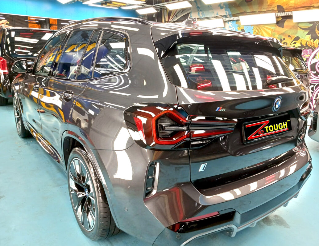 Rear quarter of the BMW iX3, glossy and protected.