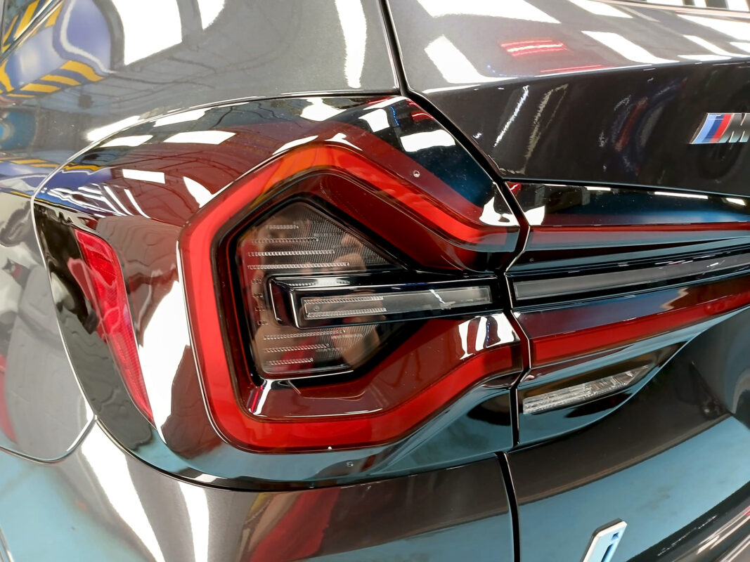 The coated bonnet of the BMW iX3 under workshop lighting.