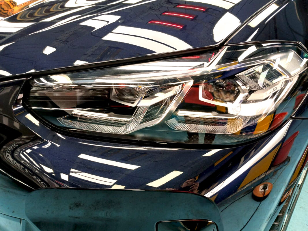 The iX3's coated paintwork showing clean reflections.