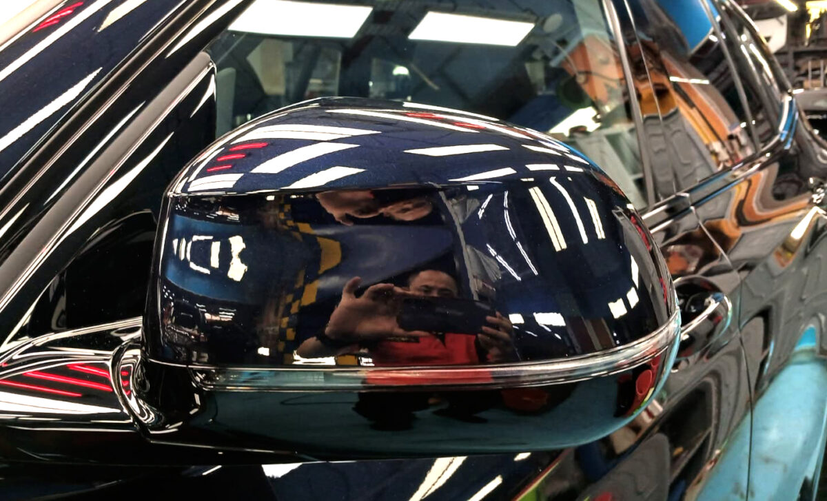 The BMW iX3 parked in the workshop, freshly coated.