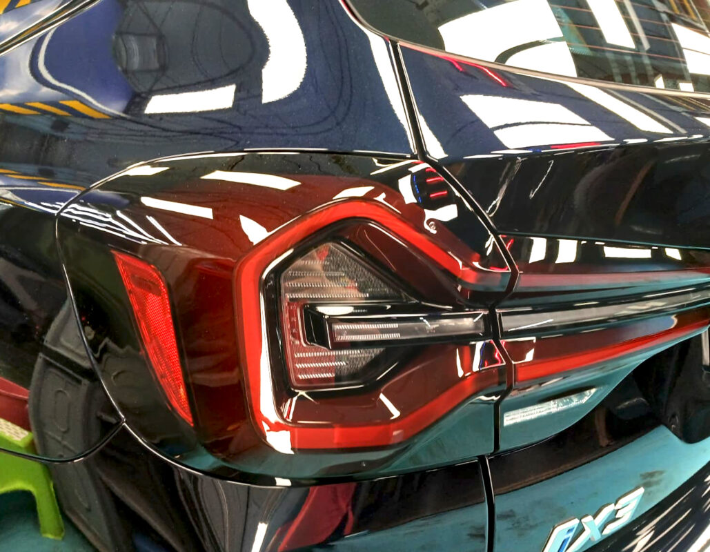 Rear quarter of the BMW iX3, glossy and protected.