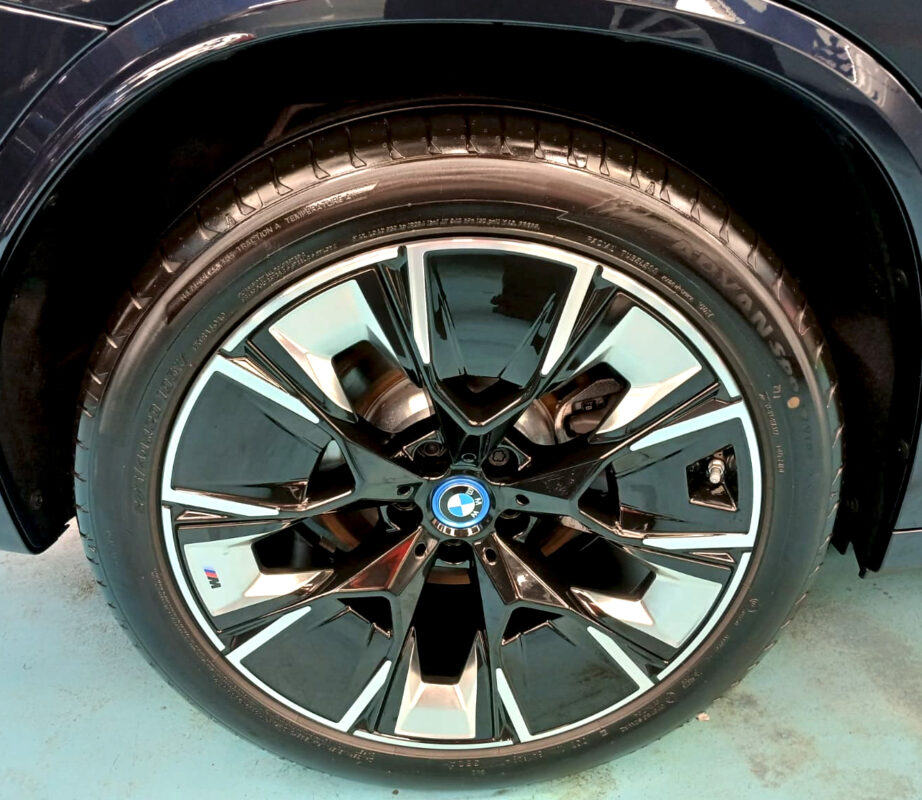 The coated bonnet of the BMW iX3 under workshop lighting.
