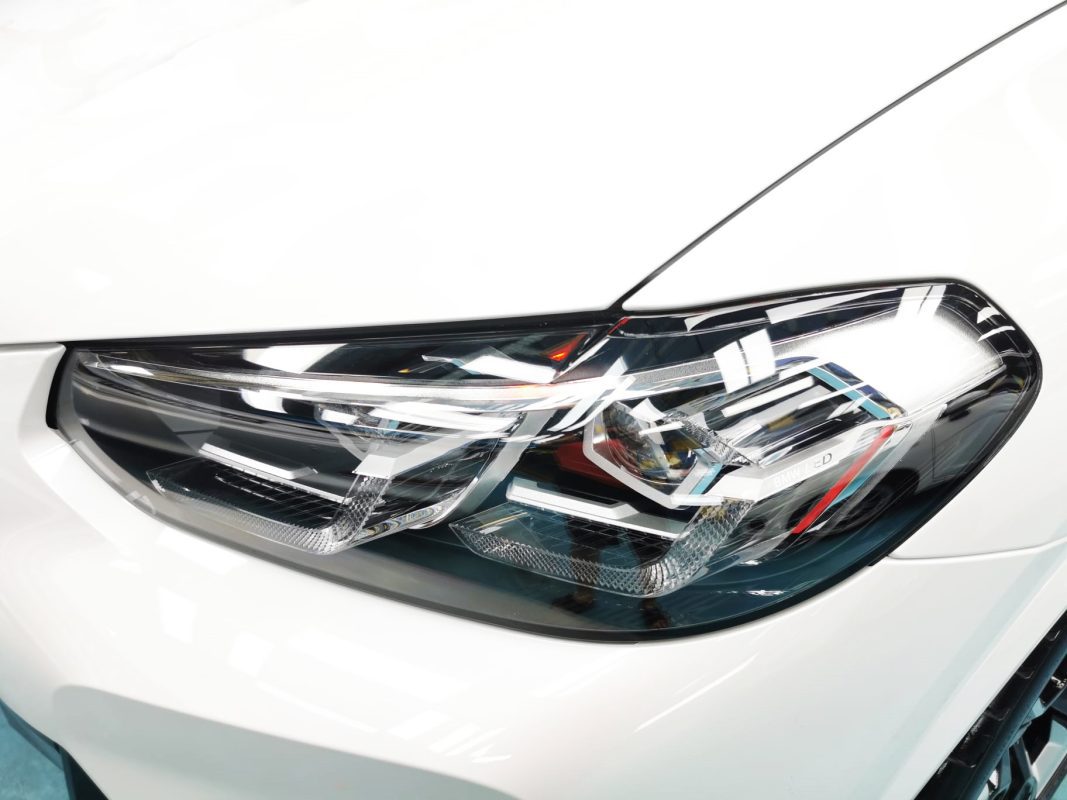 The iX3's coated paintwork showing clean reflections.