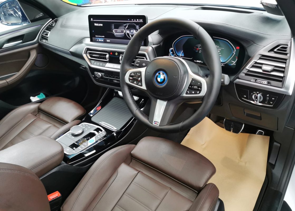The BMW iX3 parked in the workshop, freshly coated.