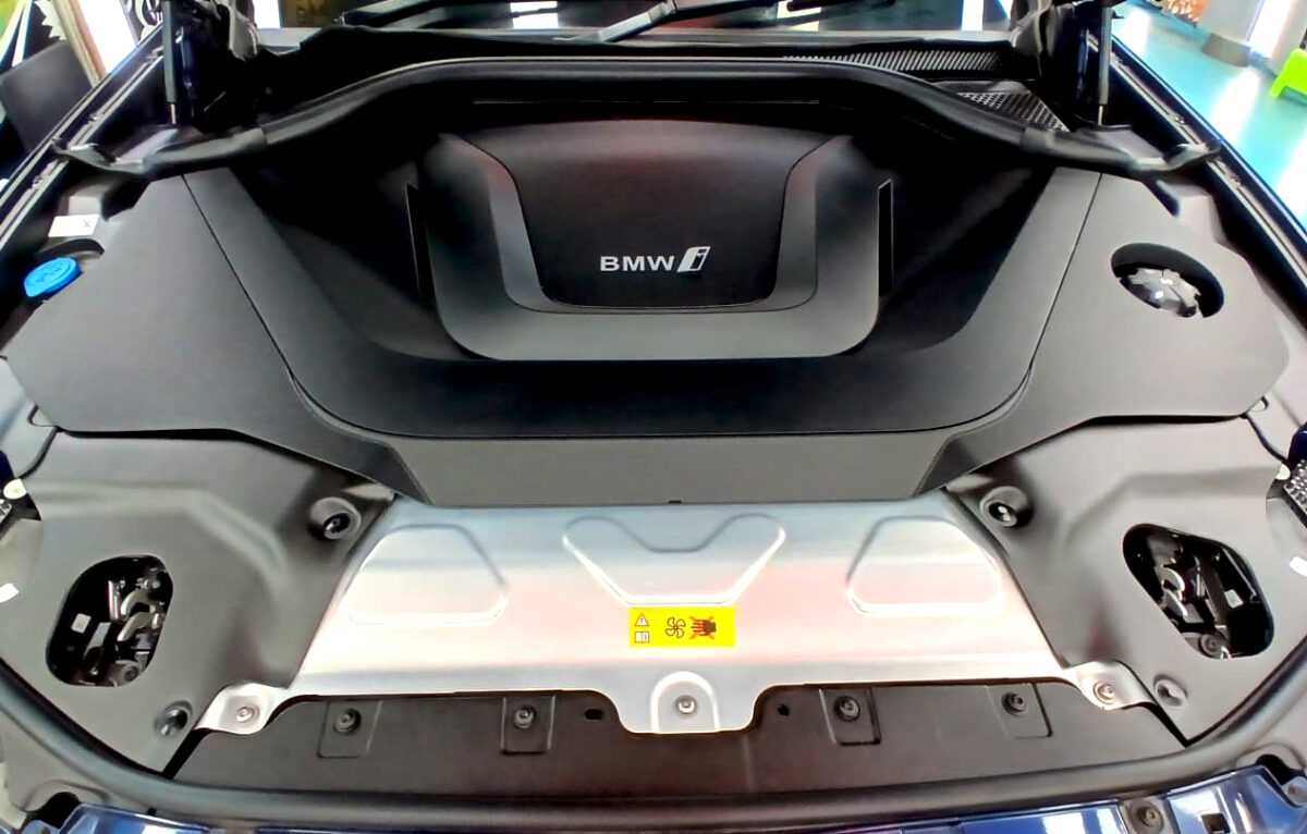 Reflections across the coated panels of the BMW iX3.