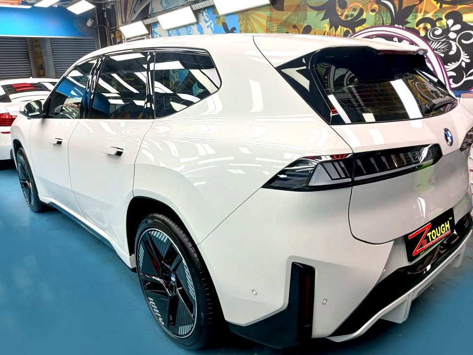 Rear three-quarter view of the white BMW iX3.