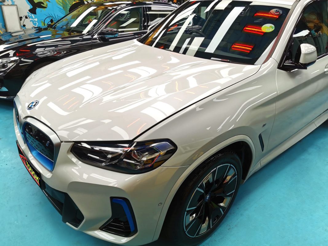 The BMW iX3 from a side angle after the titanium coating.