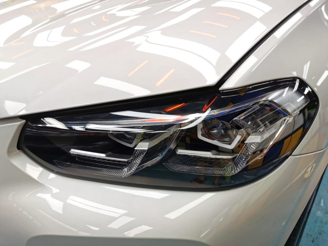 The iX3's coated paintwork showing clean reflections.