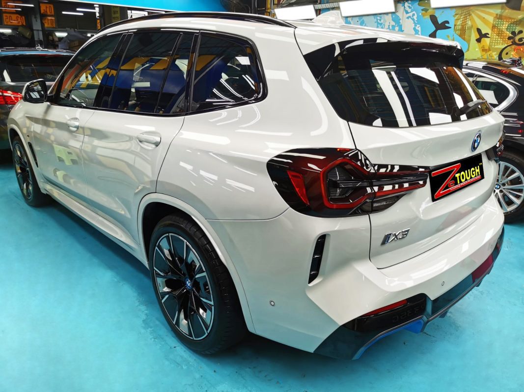 Rear quarter of the BMW iX3, glossy and protected.