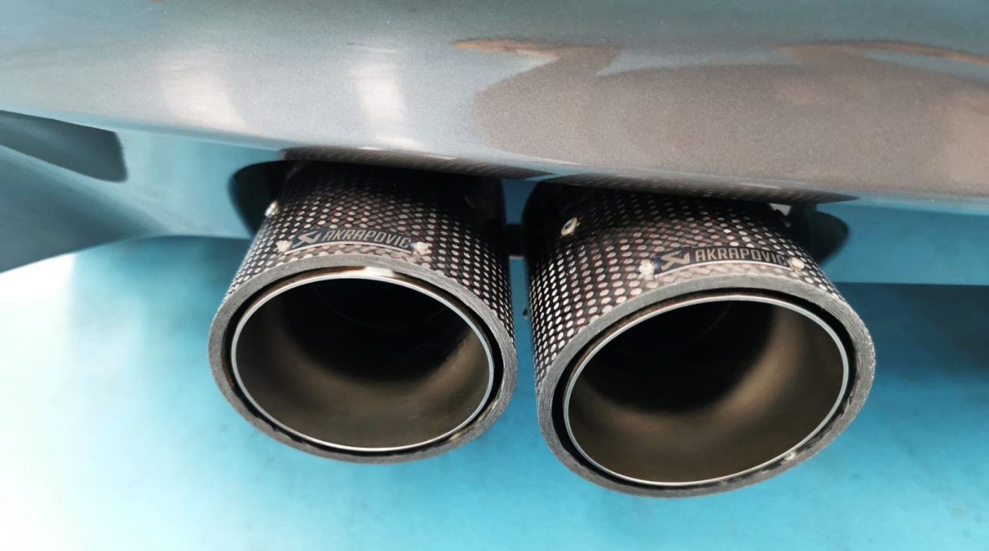 The coated bonnet of the BMW M Coupe under workshop lighting.