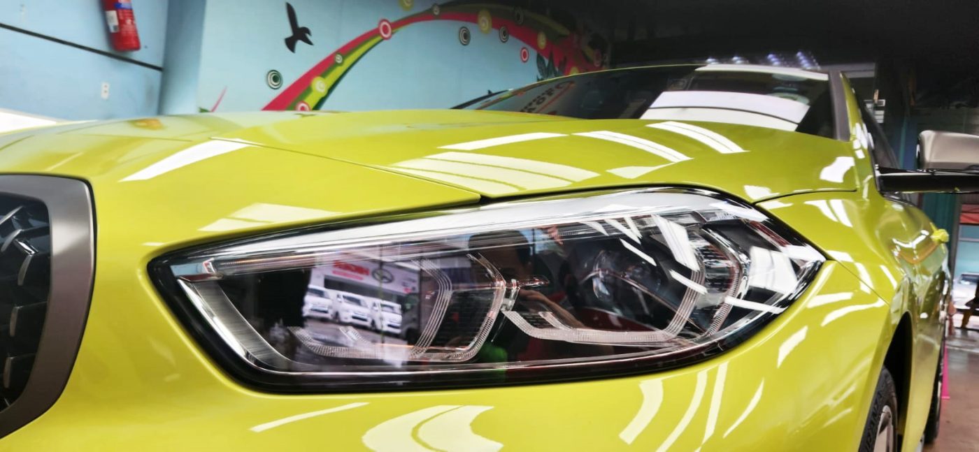 The M135i's coated paintwork showing clean reflections.