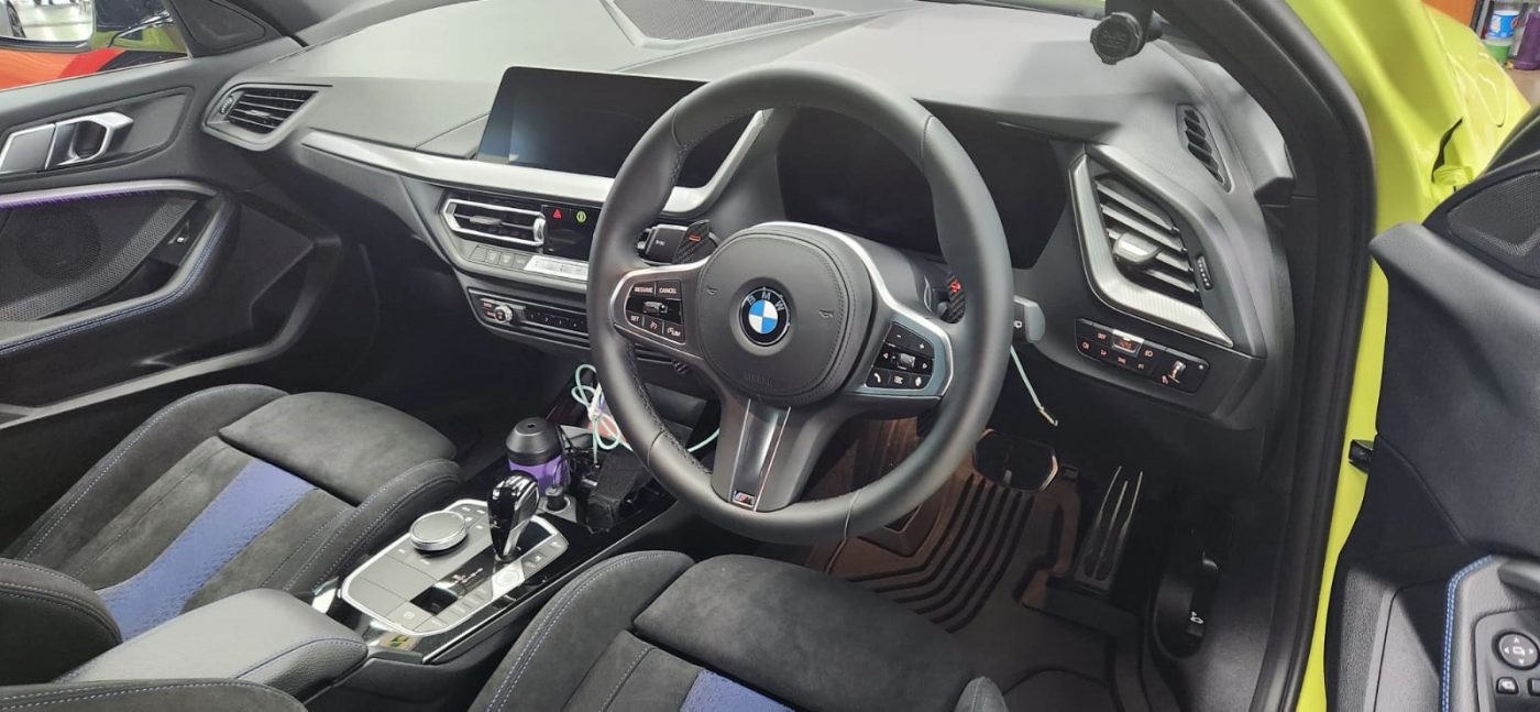 The BMW M135i parked in the workshop, freshly coated.