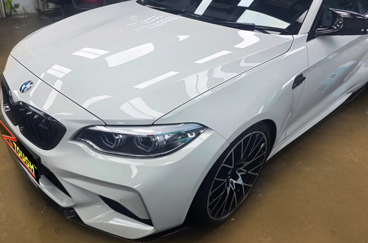 The BMW M2 from a side angle after the ceramic coating.
