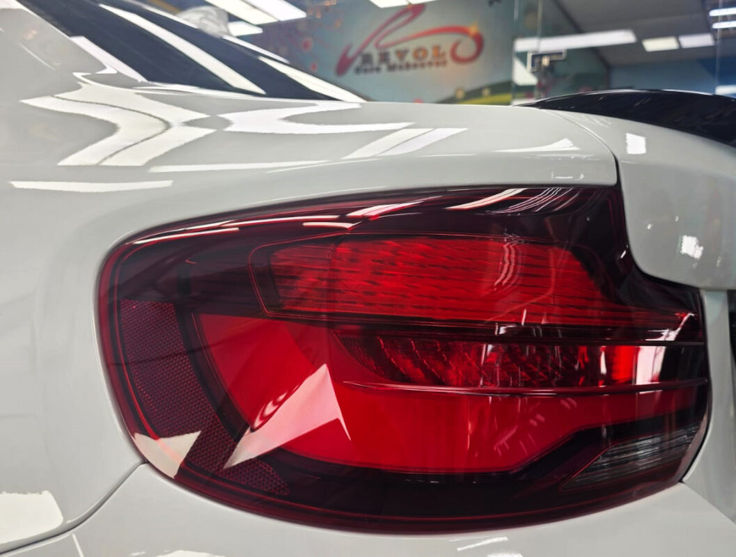 The coated bonnet of the BMW M2 under workshop lighting.