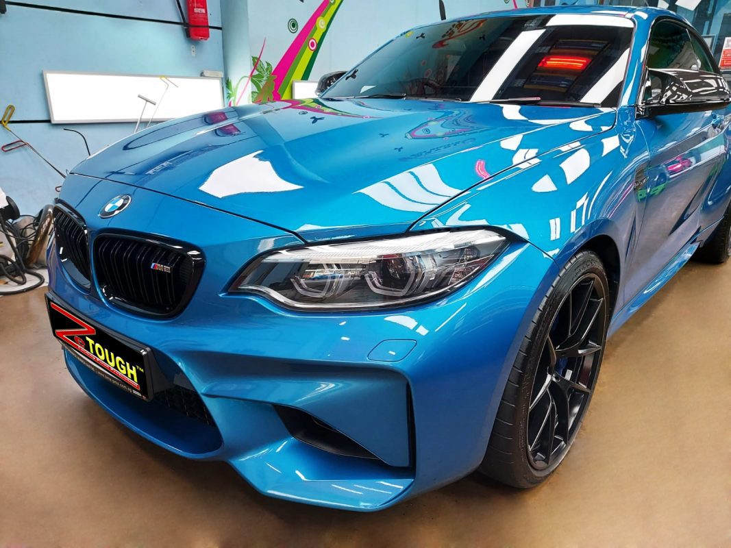 The BMW M2 from a side angle after the ceramic coating.