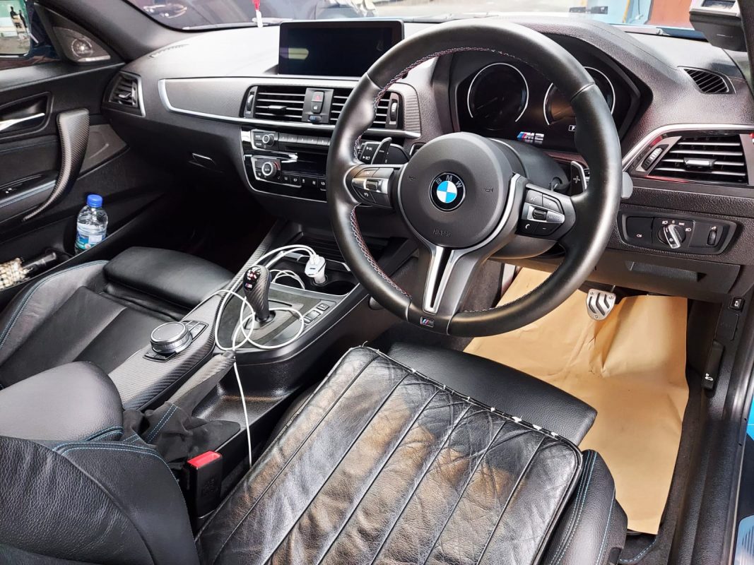 The BMW M2 parked in the workshop, freshly coated.