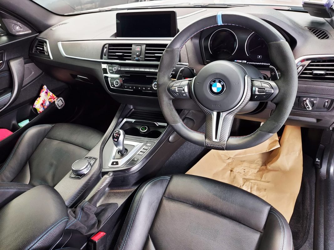 The BMW M2 parked in the workshop, freshly coated.