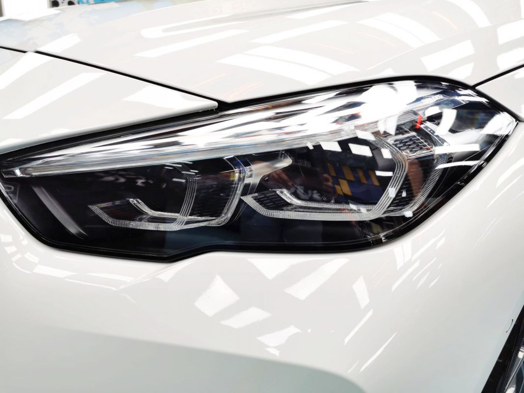 The M235i's coated paintwork showing clean reflections.