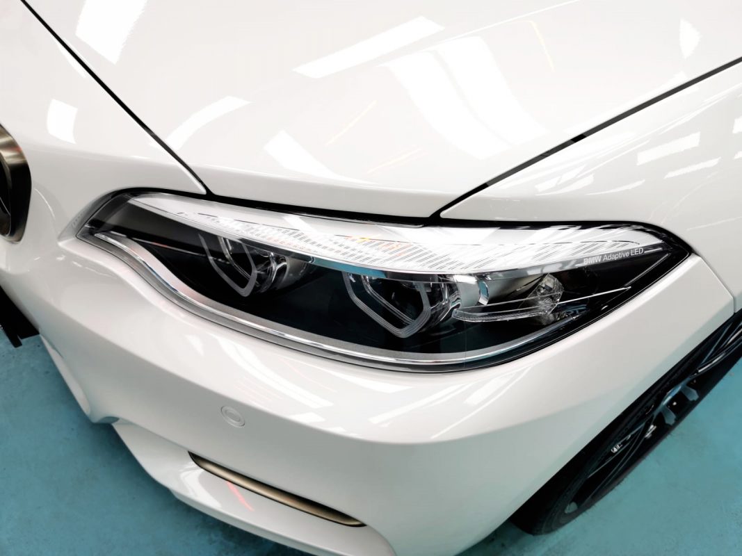 The M240i's coated paintwork showing clean reflections.
