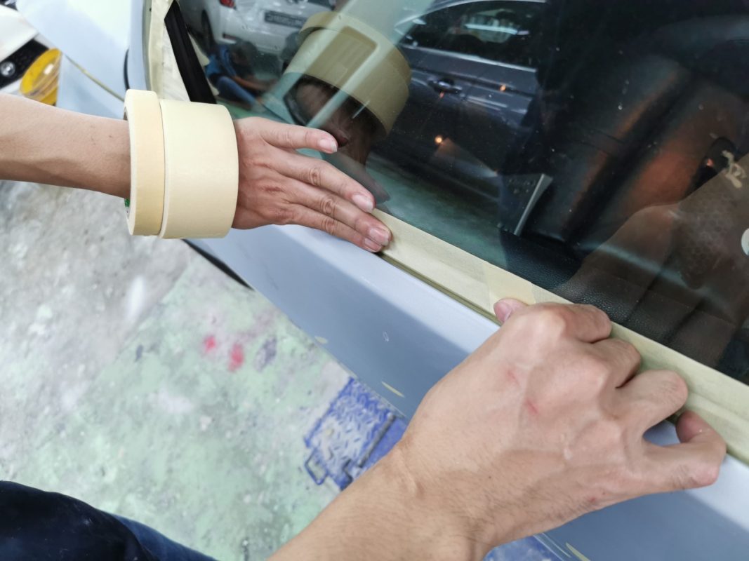 Non-painted surfaces being masked off on the M3 before spraying.