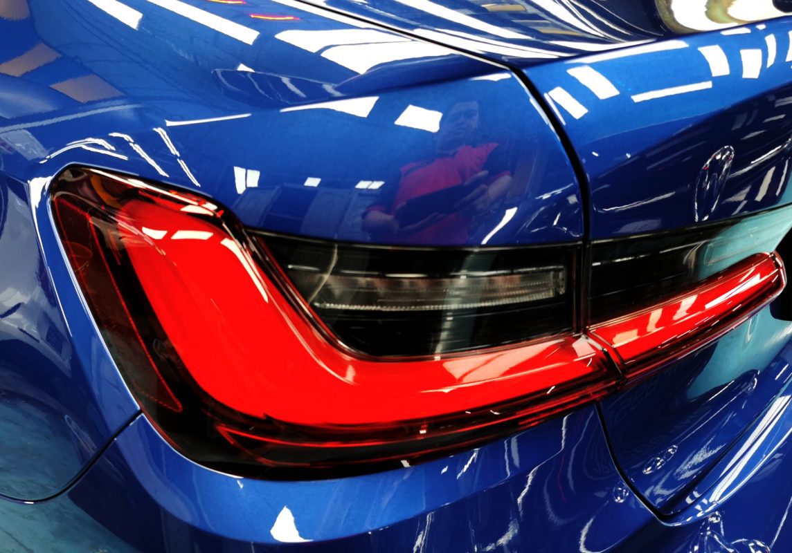 The coated bonnet of the BMW M3 under workshop lighting.