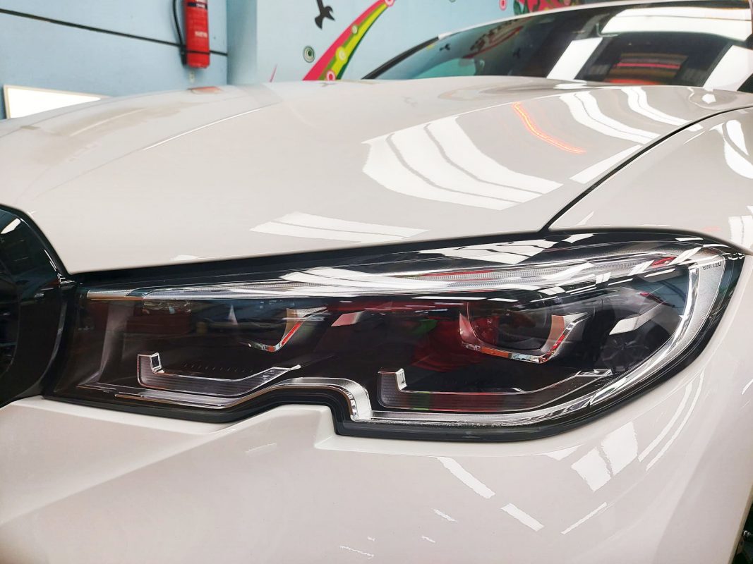The M340i's coated paintwork showing clean reflections.