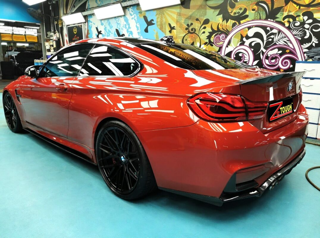 Orange-red BMW M4, glossy after its full respray.