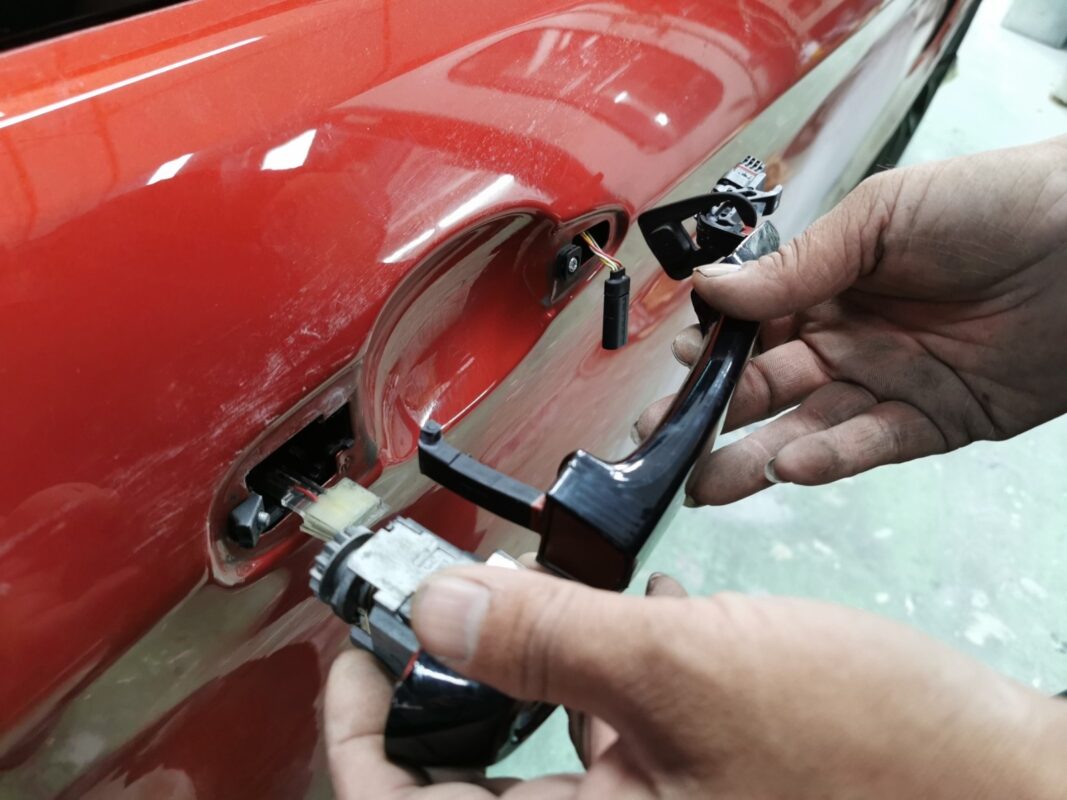 A door handle removed as the BMW M4 is stripped down for the respray.