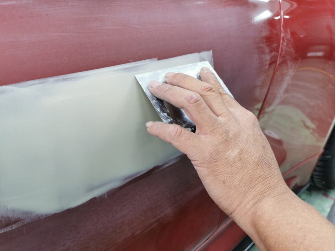 Body filler levelling a panel on the BMW M4 before paint.